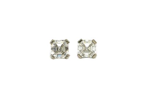 A pair of platinum and diamond single stone ear studs, each claw set with an emerald cut diamond, the diamonds weigh approximately 0.75cts each, the b