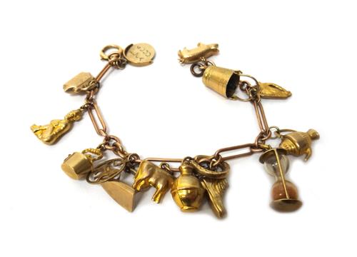 A 9ct gold bar and oval link bracelet, fitted with fifteen mostly 9ct gold charms, including a pixie, an elephant, a cow and a harp, gross weight 19.4