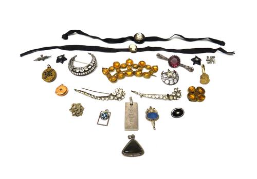 A colourless paste set brooch, designed as a crescent enclosing a star, a colourless paste set brooch, designed as a crescent, a gilt metal and black