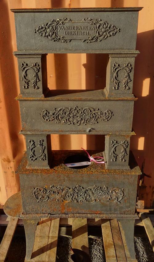 An early 20th century cast iron fire stove and a cast iron fire back. OUT