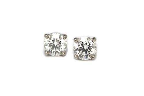 A pair of Tiffany & Co platinum and diamond set single stone ear studs, each claw set with a circular cut diamond, the posts with Tiffany & Co platinu