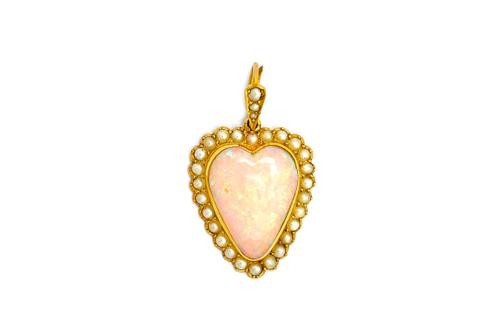 A gold, opal and half pearl set heart shaped pendant, mounted with a heart shaped opal at the centre, within a surround of half pearls, detailed 15 CT