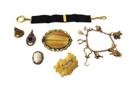 A gold curb link charm bracelet, fitted with eight mostly 9ct gold pendants and charms, including a folding button hook, a baby's pram and a teapot, g