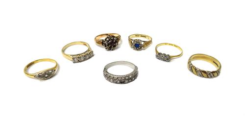 A diamond set half hoop ring, mounted with two rows of cushion shaped diamonds (one diamond lacking), a gold and platinum, diamond set three stone rin