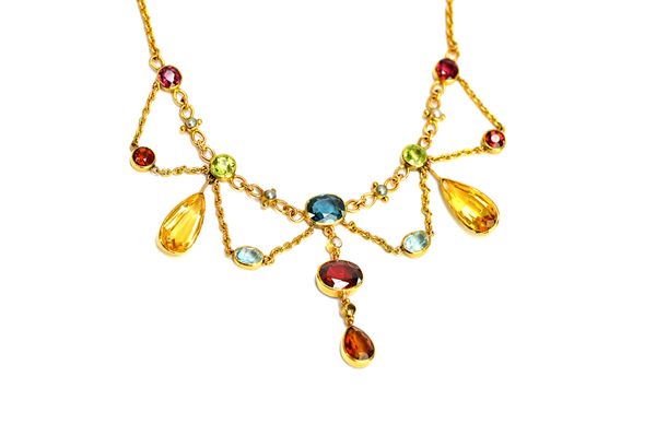 A gold, coloured gemstone and half pearl set necklace, the front in an undulating design, the variously cut coloured gemstones including; pink sapphir