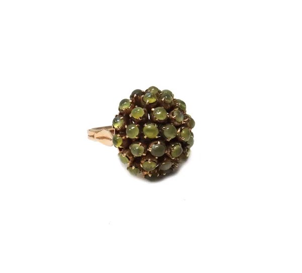 A gold and cabochon chrysoberyl cluster ring, in a bombe design, (one cabochon chrysoberyl lacking) detailed 14 K, ring size O and a half.