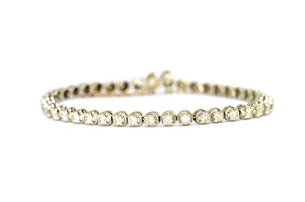 An 18ct white gold and diamond bracelet, claw set with a row of forty two circular brilliant cut diamonds, approximately 0.08cts each, on a snap clasp
