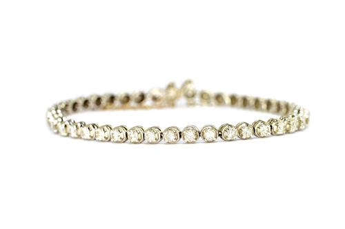An 18ct white gold and diamond bracelet, claw set with a row of forty two circular brilliant cut diamonds, approximately 0.08cts each, on a snap clasp