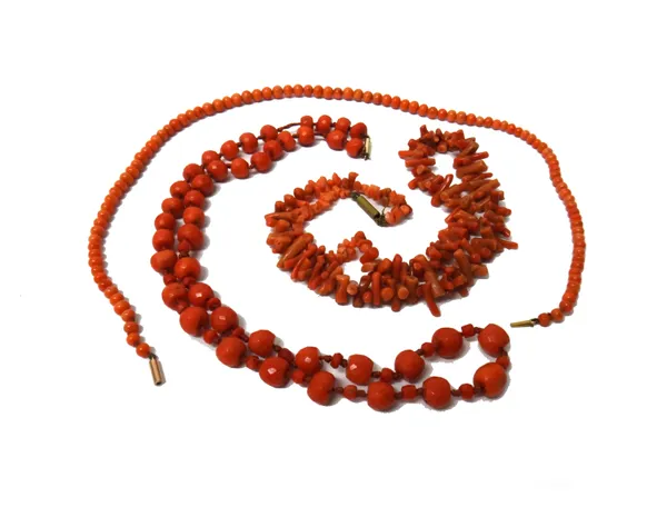 A single row necklace of faceted coral beads, a single row necklace of graduated coral beads and a single row necklace of graduated branch corals, (3)