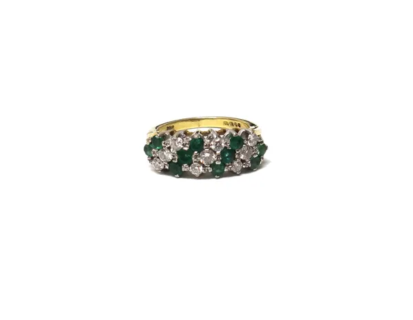 An 18ct gold, emerald and diamond ring, mounted with three rows of three circular cut diamonds alternating with four rows of circular cut emeralds, in