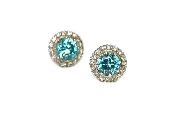 A pair of diamond and blue zircon set circular cluster earstuds, each claw set with a circular cut blue zircon at the centre, within a surround of cir