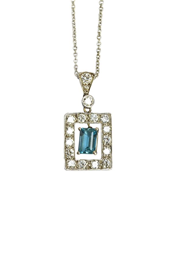 An aquamarine and diamond set pendant, in an openwork rectangular design, claw set with the rectangular cut aquamarine at the centre, in a surround of