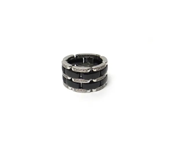 A Chanel white gold, diamond and haematite effect ceramic band ring, of articulated form, having three rows of small circular cut diamonds, alternatin