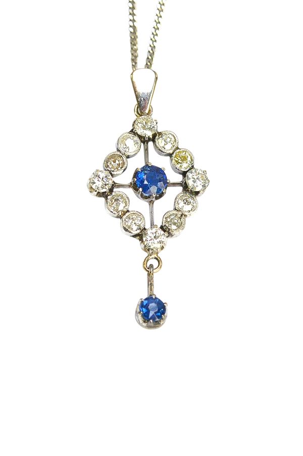 A sapphire and diamond pendant, in an openwork lozenge shaped cluster design, claw set with the circular cut sapphire at the centre, in a surround of