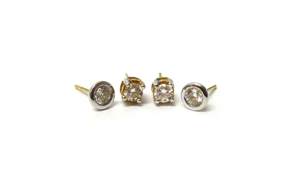A pair of gold and diamond set single stone earstuds, each claw set with a circular cut diamond, the backs with post fittings and another pair of gold