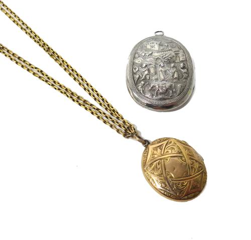 A Victorian gold back and front oval pendant locket, with floral and scroll engraved decoration, glazed with photographic portraits within, with a two