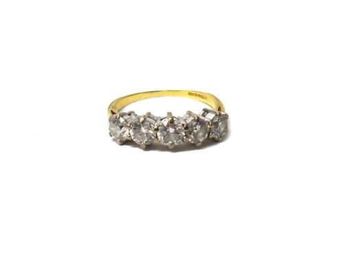 An 18ct gold and diamond set five stone ring, claw set with a row of circular cut diamonds, ring size O, with a case.