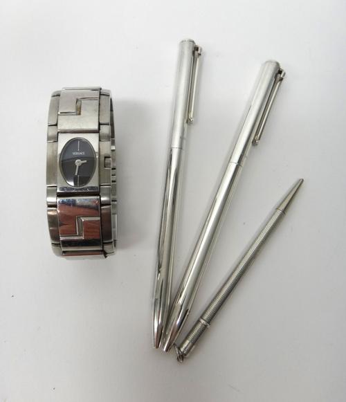 Two Tiffany & Co silver cased ball point pens, with a pink leather slip case, detailed Aspinal of London, a Sterling silver cased propelling pencil an