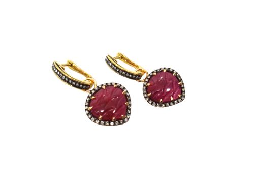A pair of 18ct gold, ruby and diamond earrings, each heart shaped drop centred by a carved ruby, within a surround of circular cut diamonds, the tops