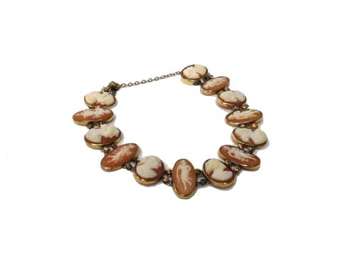A gold mounted, oval shell cameo link bracelet, the links carved alternately as standing female figures and bust portraits of ladies, on a snap clasp,