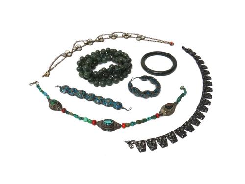 A collection of Eastern and other jewellery, comprising; two turquoise matrix bracelets, a circular green stone bangle, a single row necklace of green