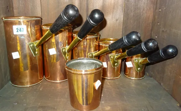 Copper wares, comprising; a set of five 20th century graduated jugs with turned wooden handles and a smaller similar beaker. (6) Rost