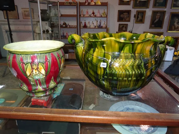 A large 20th century green majolica twin handled jardiniere and a smaller green and red Art Nouveau jardiniere, (2). G5