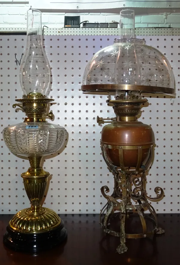 A Victorian brass and cut glass oil lamp and a copper oil lamp with star cut glass shade, (2).  Rost