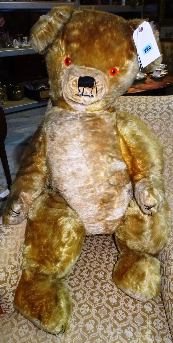 A large mid-20th century straw filled teddy bear, 110cm high G3