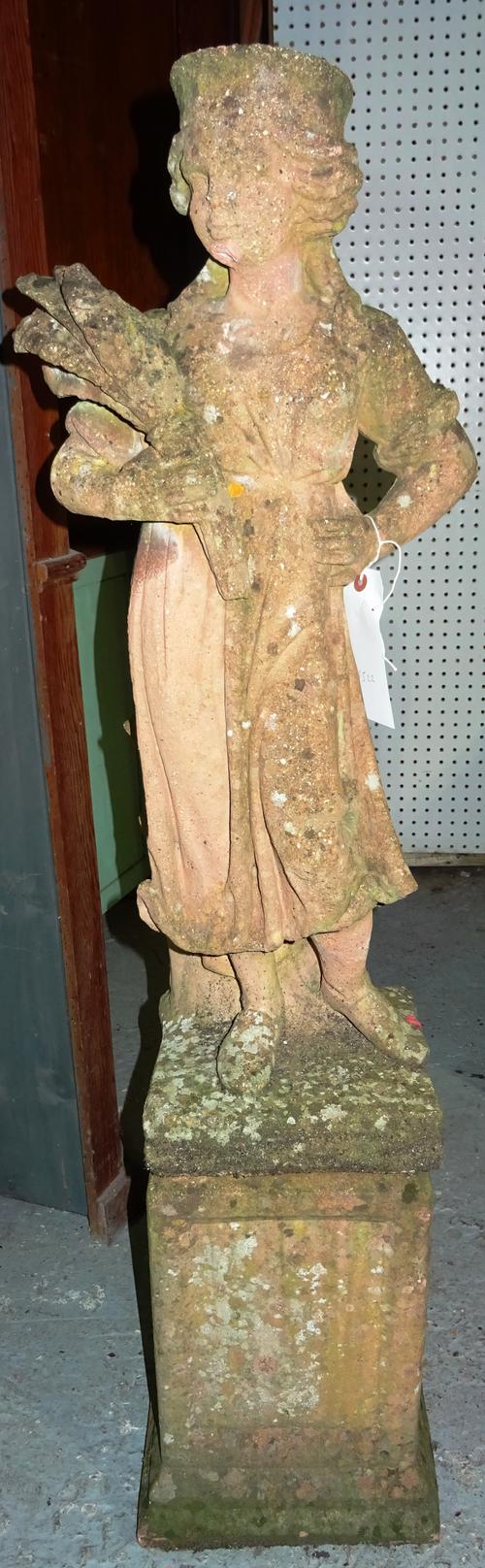 A 20th century reconstituted stone figure carrying corn on plinth base, 115cm high. K6