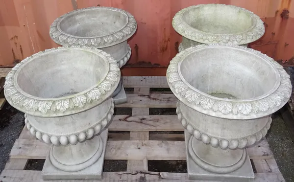 A set of four 20th century reconstituted stone urns with floral carved acanthus rim. (4) B5