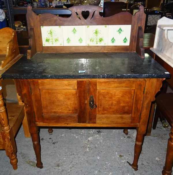 A late 19th century walnut washstand, with tiled galleried back and granite top, 84cm wide. K2