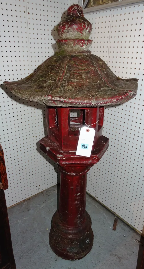 A red glazed Chinese style lantern, on turned column, indistinctly marked, 125cm high. M11