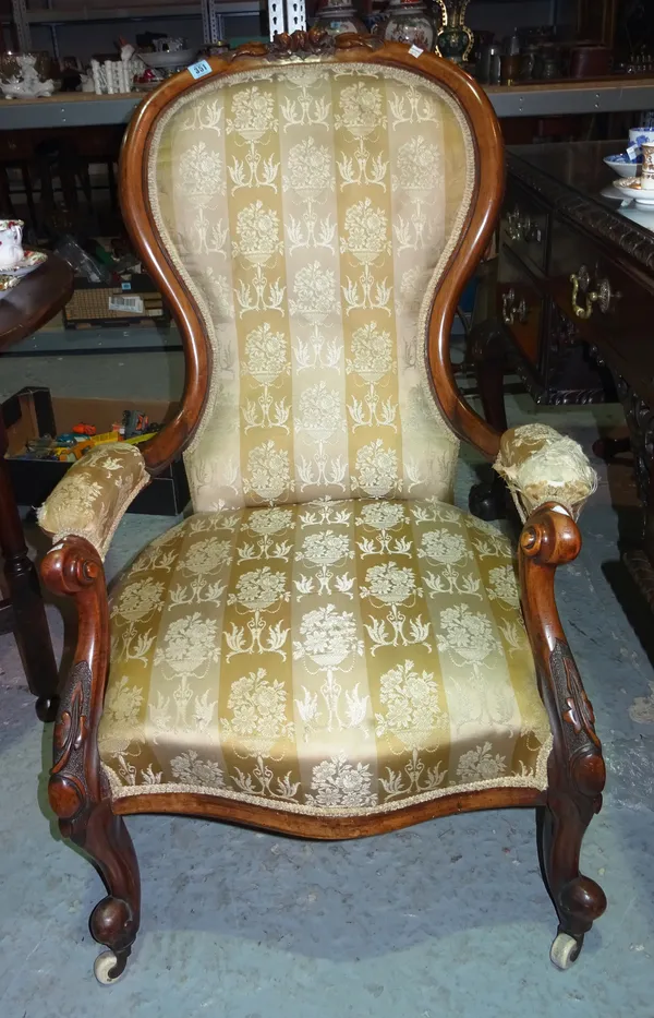 A Victorian carved walnut framed upholstered open armchair. I3