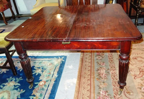 A George IV/early Victorian mahogany extending dining table, with two leaves (damaged), 214.5cm fully extended. J9