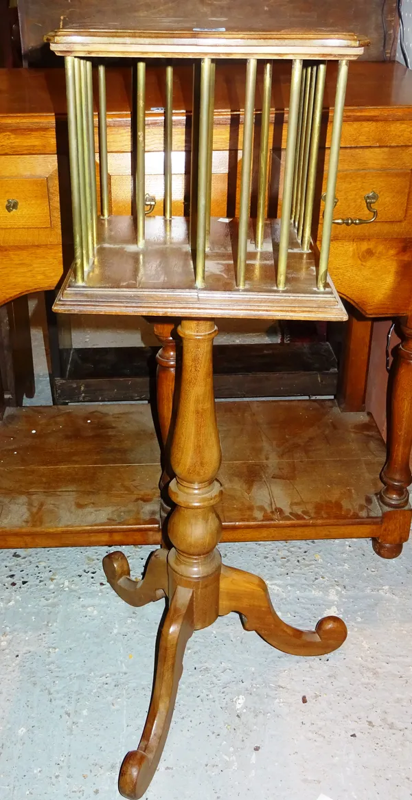 An Edwardian mahogany tripod table with tubular brass mounted revolving bookcase top, patent label, 32cm wide. E5