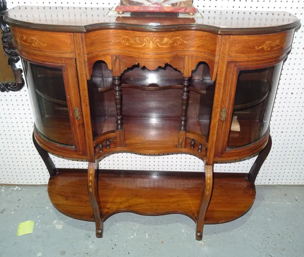 An Edwardian faux rosewood serpentine side cabinet, on scroll supports, 117cm wide x 103cm high. D10