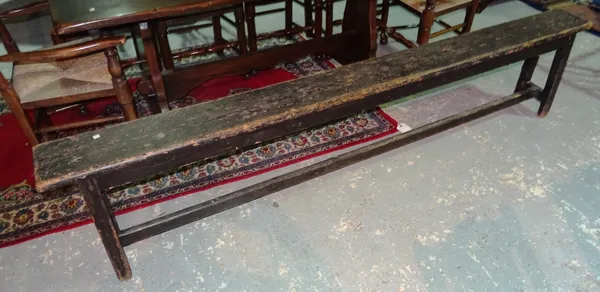 A 19th century painted pine bench, on trestle end supports united by a stretcher, 244cm long x 51cm high. H8