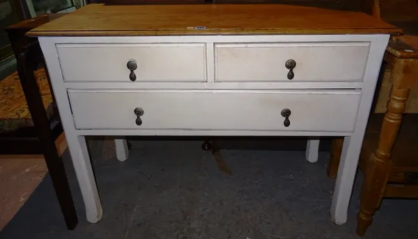A 20th century white painted side table, with oak top and two short and one long drawers, on square block supports, 106cm wide x 78cm high. K1