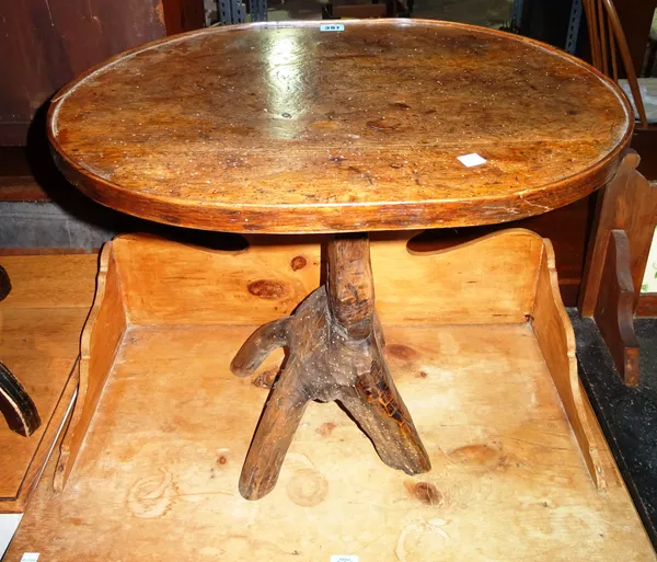 A 19th century Provincial mixed wood small occasional table, on 'branch' support, 43cm wide. H6