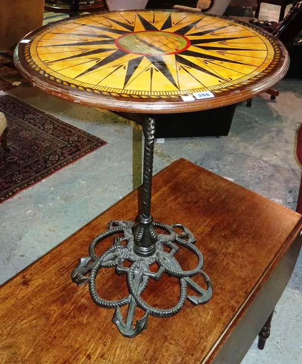 A late Victorian cast iron nautical themed occasional table, with a later polychrome decorated top, 60cm wide x 76cm high. F4
