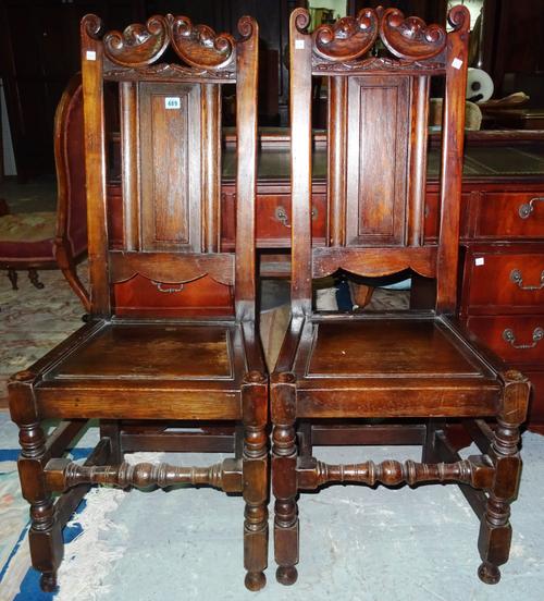 A set of four 20th century oak panel back dining chairs, with solid seats, (4). H6