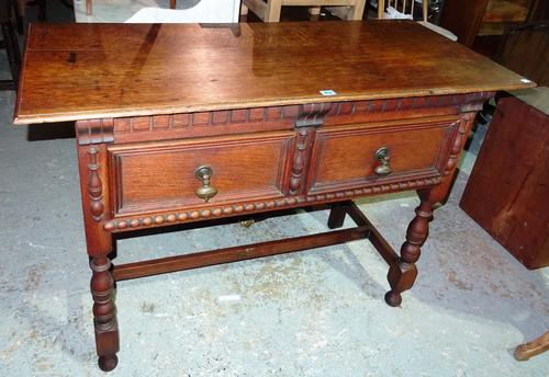 A 20th century oak two drawer side table, on turned supports united by stretcher, 122cm wide. K3