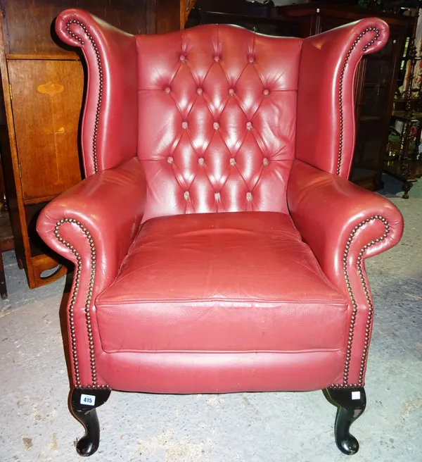 A 20th century pink leatherette wing armchair. H4