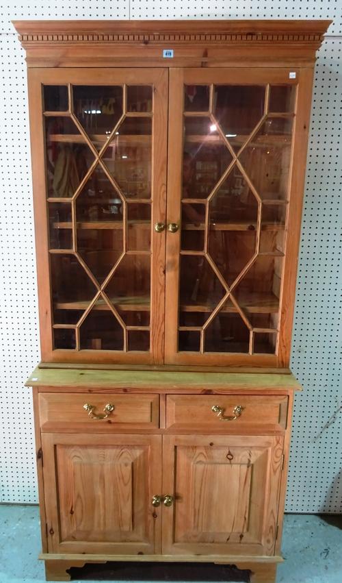 A 20th century pine bookcase cabinet, with astragal glazed doors over cupboard base, 98cm wide. G10