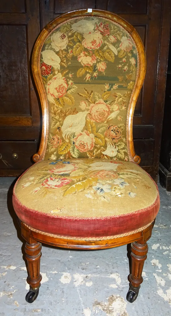 A Victorian rosewood spoon back low chair, with contemporary floral needlework upholstery. K10