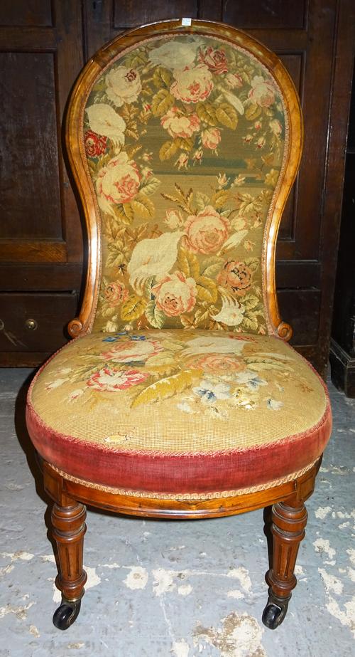 A Victorian rosewood spoon back low chair, with contemporary floral needlework upholstery. K10
