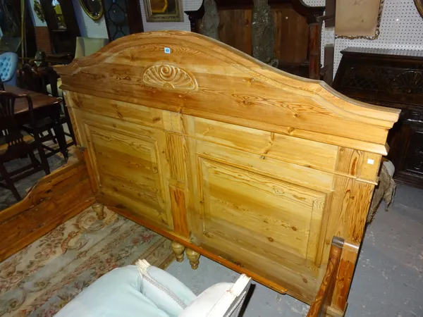 A 19th century pine king size bed, 143cm high. K10