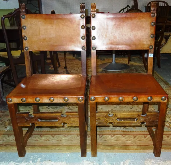 A set of four 19th century Spanish leather chairs, each united by a carved stretcher, (4). J6