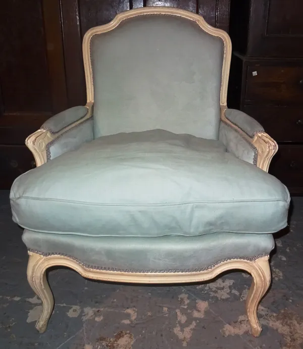 A white painted upholstered armchair, on cabriole supports. K10